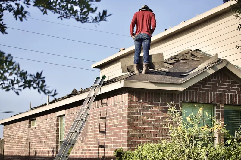 Professional roofer working on a residential roof in Cologne